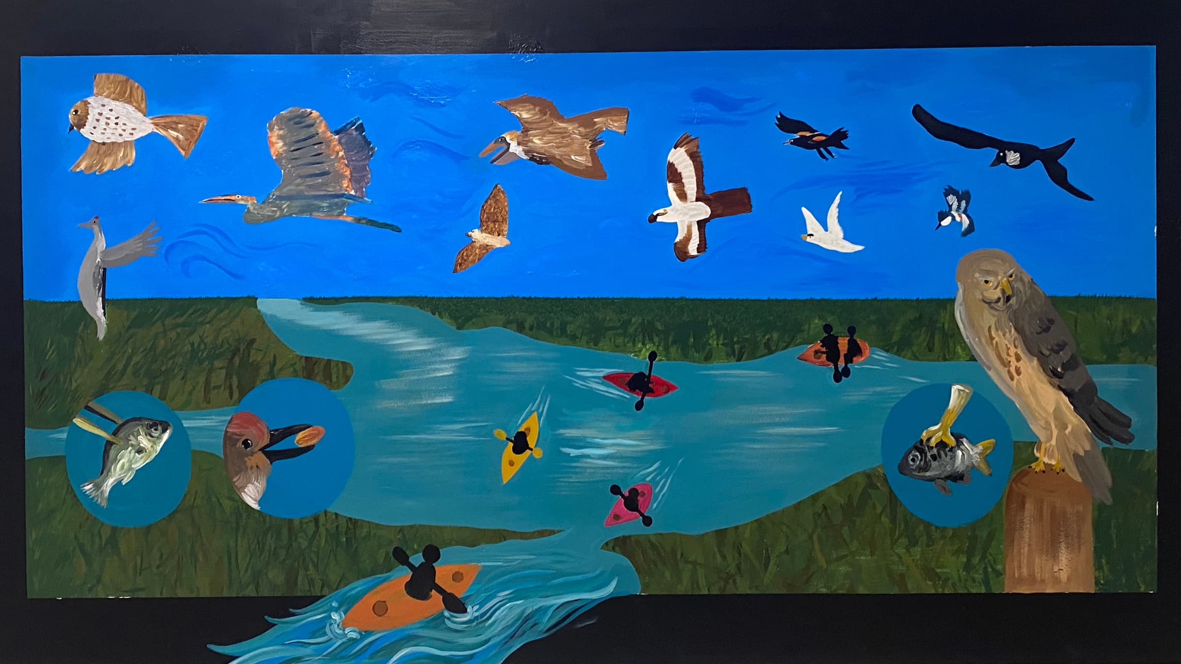 a school mural of flying birds, kayakers, and fish in a saltwater marsh