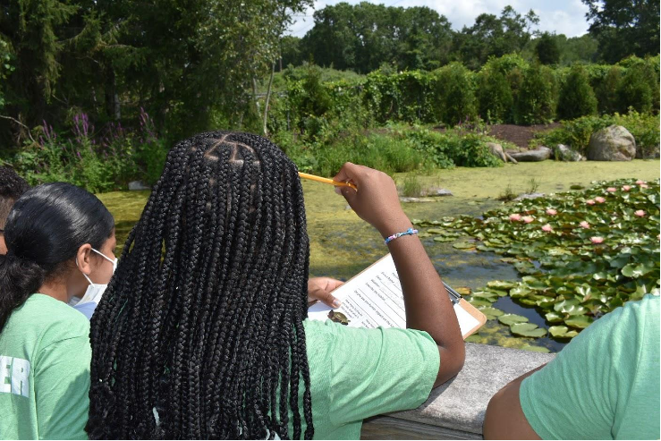 Gladstone Elementary School 21st CCLC student learning to collect data on an Amphibian Marsh Watch at Mystic Aquarium. Photo by Ayana Melvan.