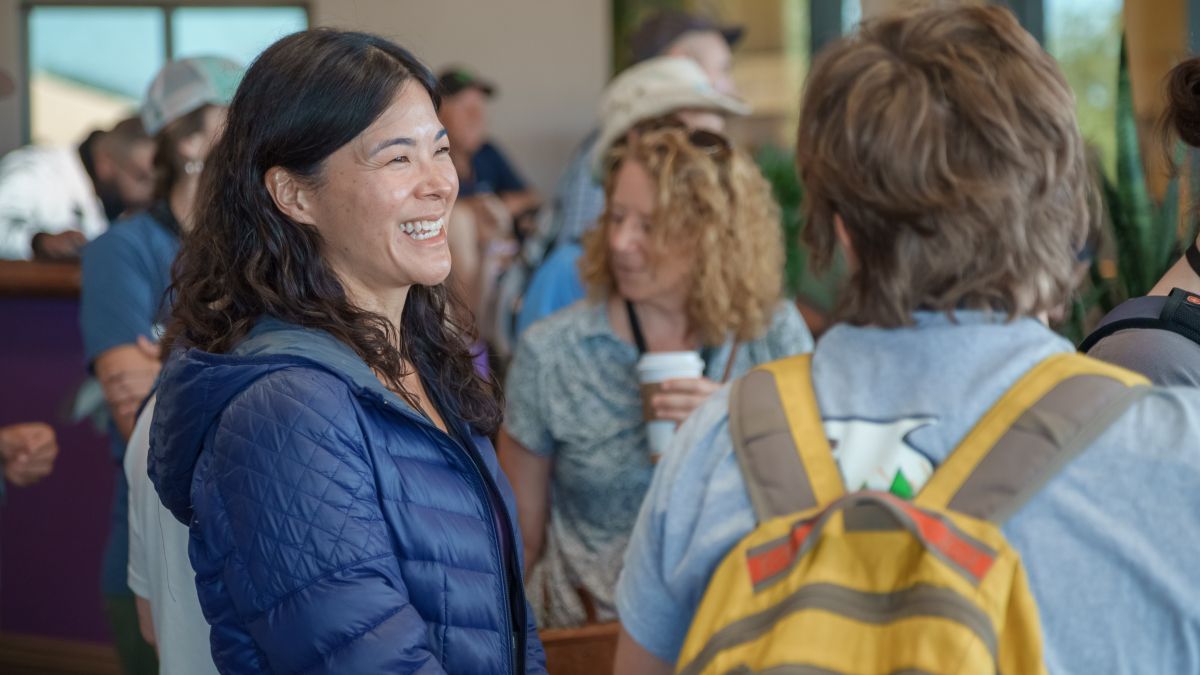 A person smiles at a group of people