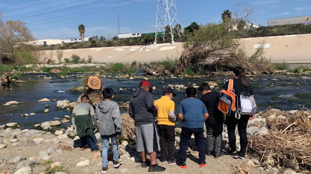 A group of students at the edge of the Los Angeles River