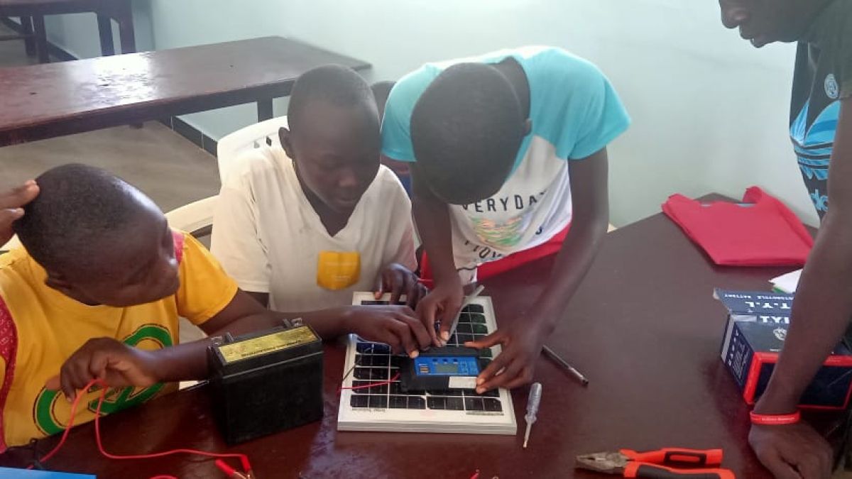 Students engage with a circuit board.  