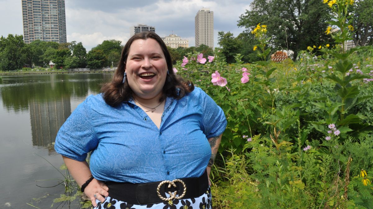 CJ smiles in front of the Chicago skyline