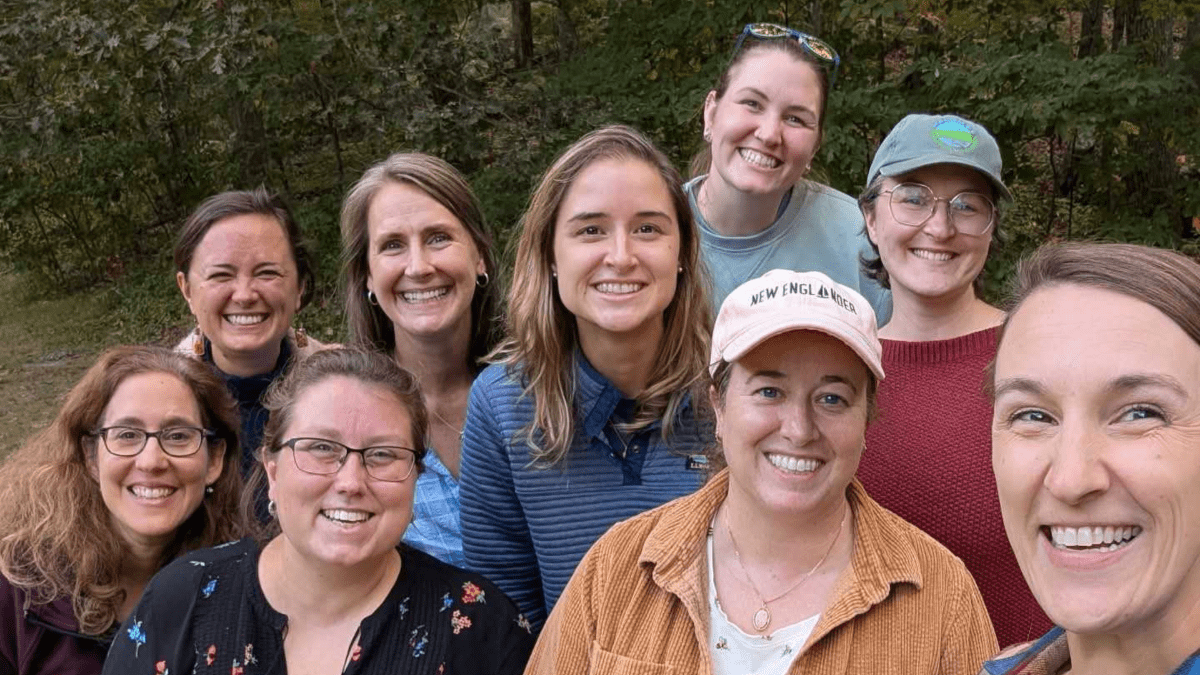 Group of people smile for a photo. Photo credit: Kristen Swanberg