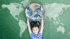 Girl holding the Earth over her head smiling