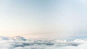 Photo of clouds and the very peaks of a mountain range