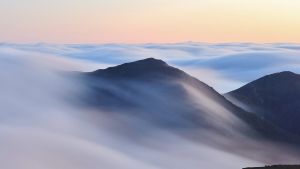 An inversion trapped low level moisture making for a stratus layerthat flowed over and around neighboring peaks.