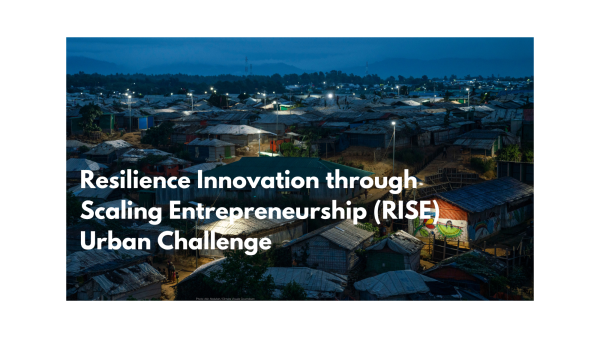 Text on an image of a crowded urban settlement at night: "Resilience Innovation through Scaling Entrepreneurship (RISE) Urban Challenge".