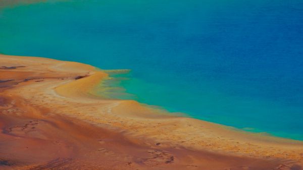 Brown sand meets a body of water