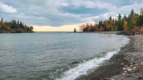 A rocky lakeshore lined by trees in autumn. Photo credit: LKaihoi / Pixabay A rocky lakeshore lined by trees in autumn