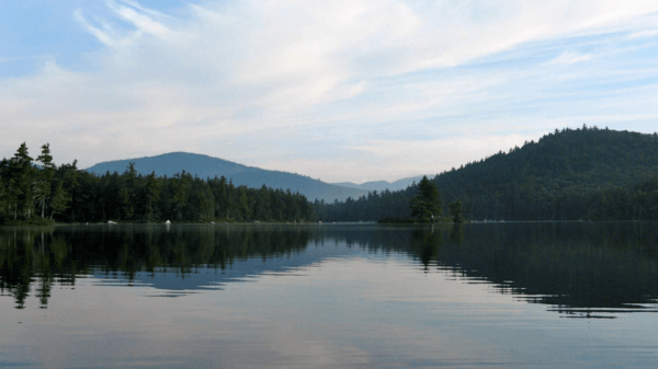 Albany Mountains and a lake under a blue sky with some clouds