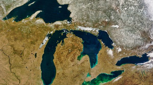 An aerial view of the Great Lakes, surrounded by a brownish landscape