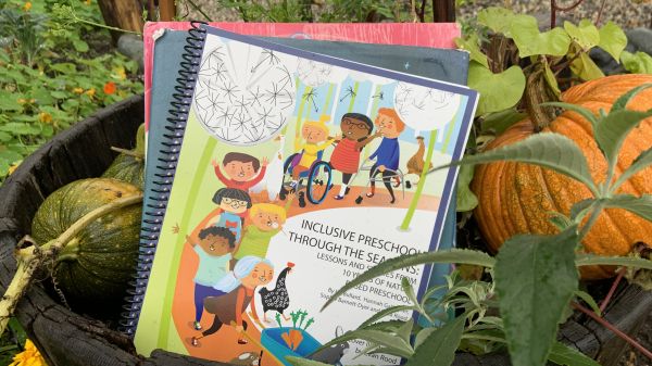 Picture of the book in a whiskey barrel with pumpkins around it