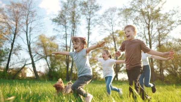 Kids running in a park on a sunny day