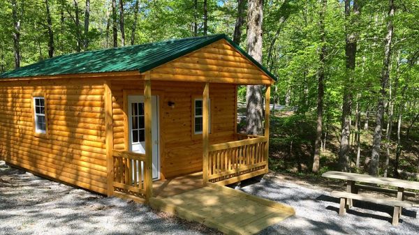 Large wood cabin with ramp within a forest
