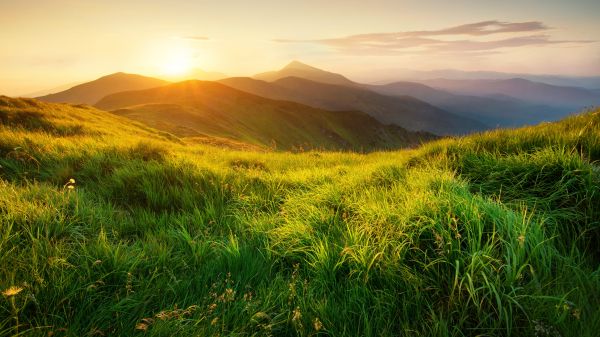 Sun rising over mountain range