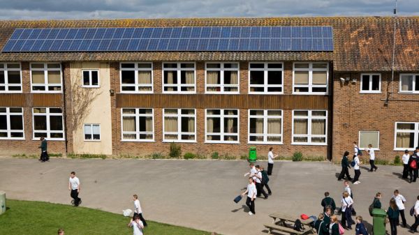 Solar PV panels on the roof above a playground. Photo credit: Andy Aitchinson / Ashden