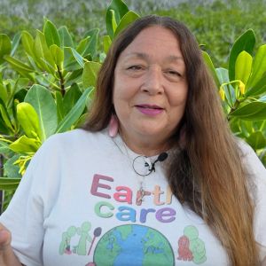 Gail Woon talking about EARTHCARE near a mangrove tree