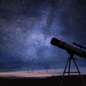 Telescope against a backdrop of a plethora of stars amidst midnight blue