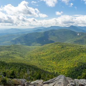 Waves of forest-covered mountains on a semi-cloudy, sunny day