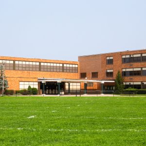 red brick school building and green grass