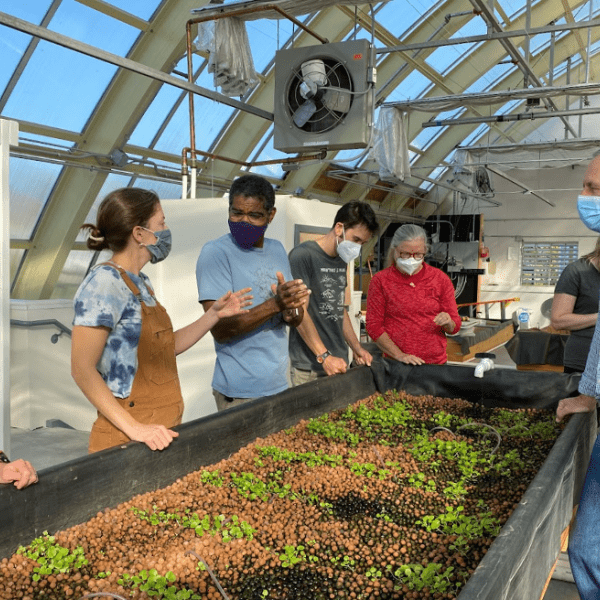 Science teachers from Brunswick High School explore the Canopy Farms facility with hosts Kate Holcomb and Theo Willis, discussing connections to their course curriculum. 