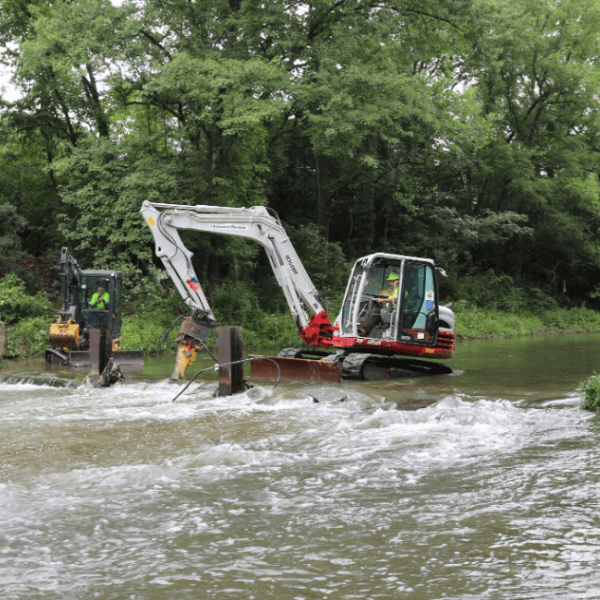 A small dam is removed along Mill Creek to restore free and unobstructed flow in the creek. 