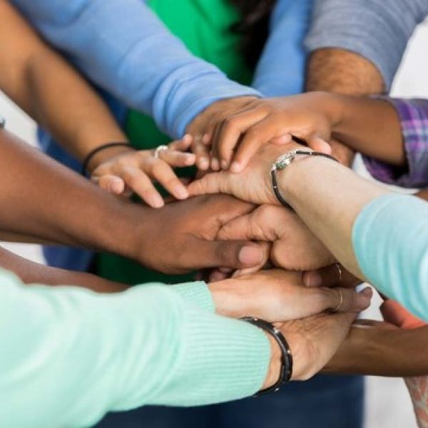 many hands are joined together