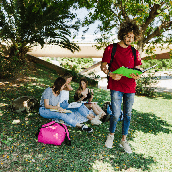 Young people reading and spending time together in the park 