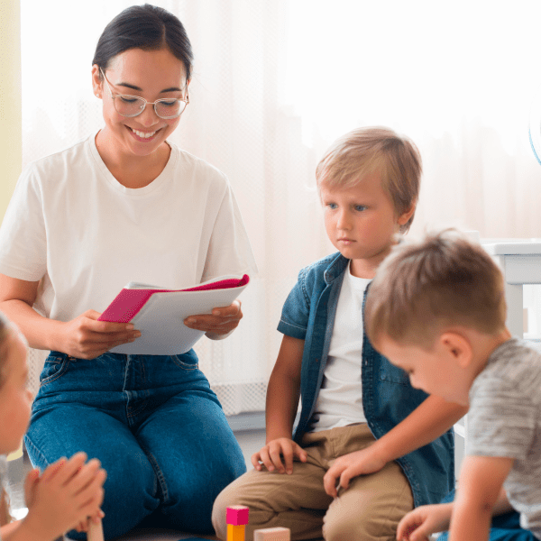 Teacher reading to young children 